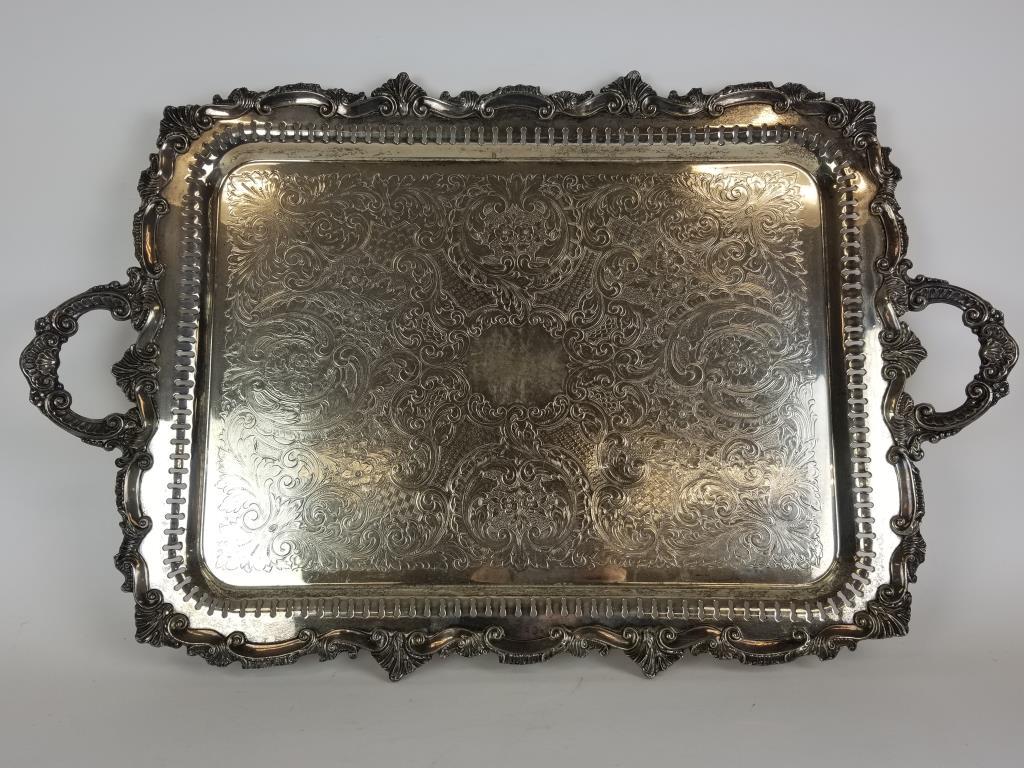Large silver plate serving tray: Ornate silver plated serving platter. Measures 30 inches wide x 19 inches deep. Touch marked on the back.