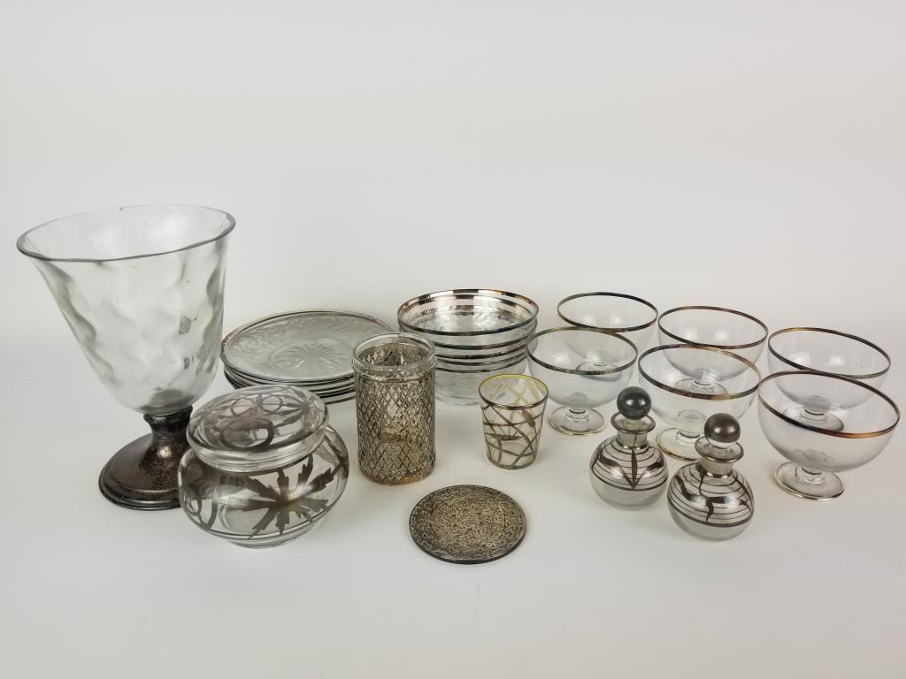 Sterling silver trimmed glass grouping: Sterling silver trimmed glassware. 24 pieces including 6 sherbets, 5 cut glass berry bowls, 6 cut glass saucers, 2 cruets, shot glass, juice glass, covered dish, Webster coaster and Hawkes vase. Vase