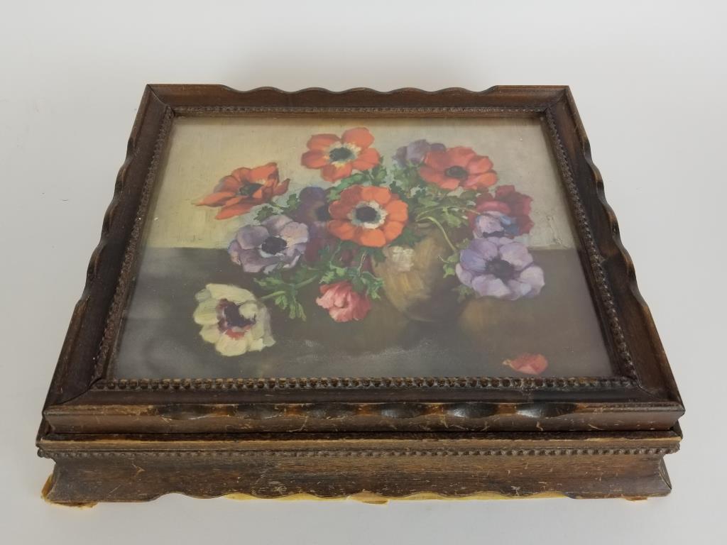 Framed flower lidded dresser box and contents: Wood dresser box, with framed floral print lid. Mirror on inside of lid. Includes contents, some jewelry and watch bands. Mirror is cracked. Measures 12.5 inches wide x 10.5 inches deep x 3 inches tal