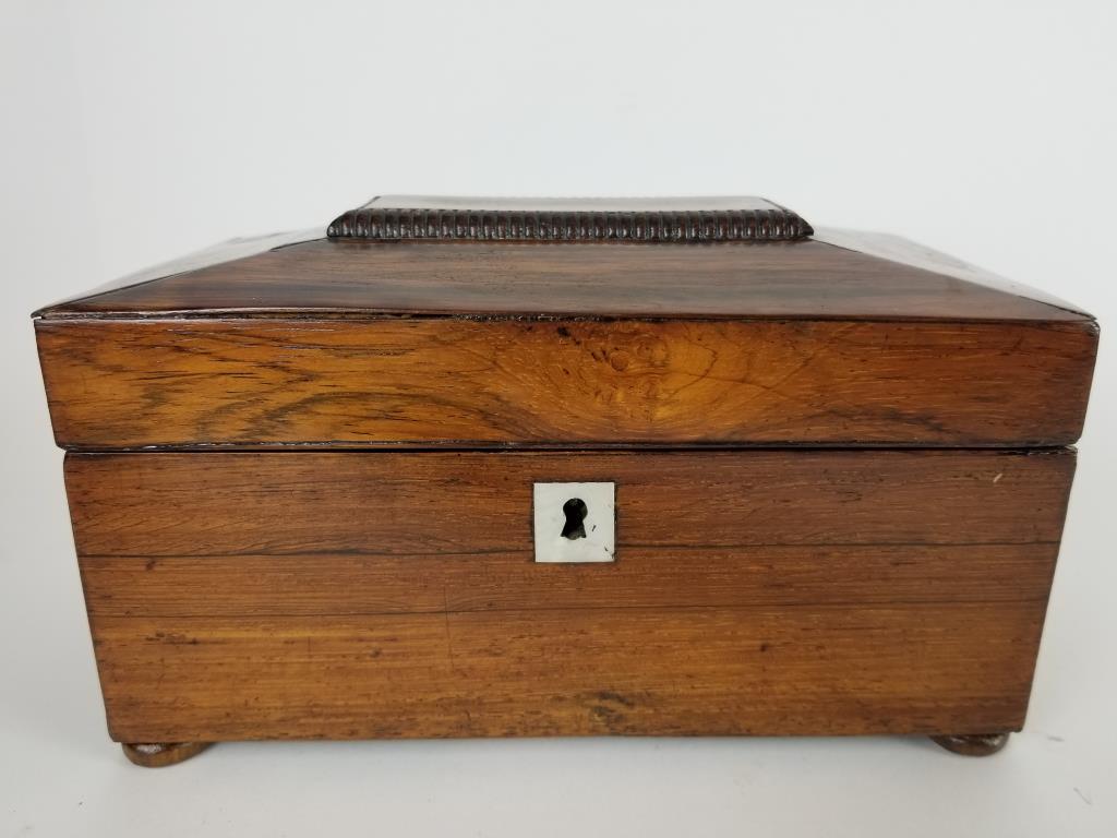 Wooden antique tea caddy: Wooden tea caddy with inlaid mother of pearl escutcheon. Measures 5.25 inches tall x 9 inches wide x 5 inches deep.