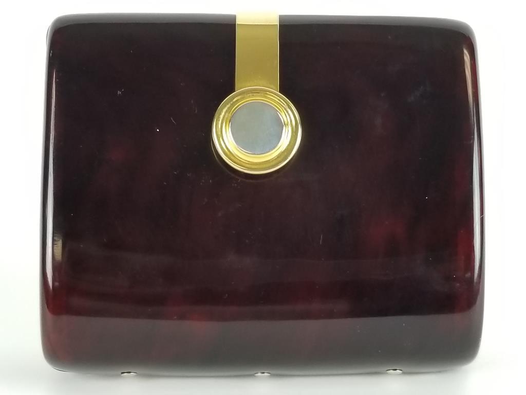 Vintage Mark Cross clutch handbag: Vintage tortoise-shell lucite clutch, with gold and sliver tone closure. Inside is leather lined and has 2 anchor to attach a hideaway carry chain. Measures 5 inches high x 6 inches wide x 2 inches de