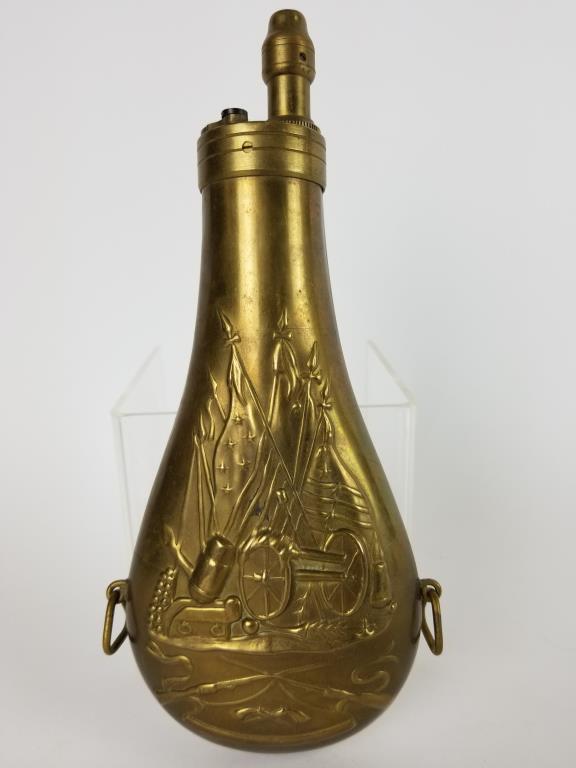 Brass powderhorn: Made in Italy, brass powderhorn, early American embossed cannon scene. Measures 9 inches tall.