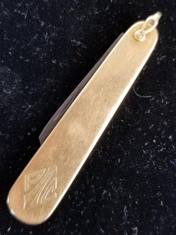 14k gold Miller Bros pocket knife: Miller Bros, 14k gold pocket knife watch chain fob. Initials engraved into the front. Measures 2.5 inches long. Blade is worn and is not gold. Dent on back.