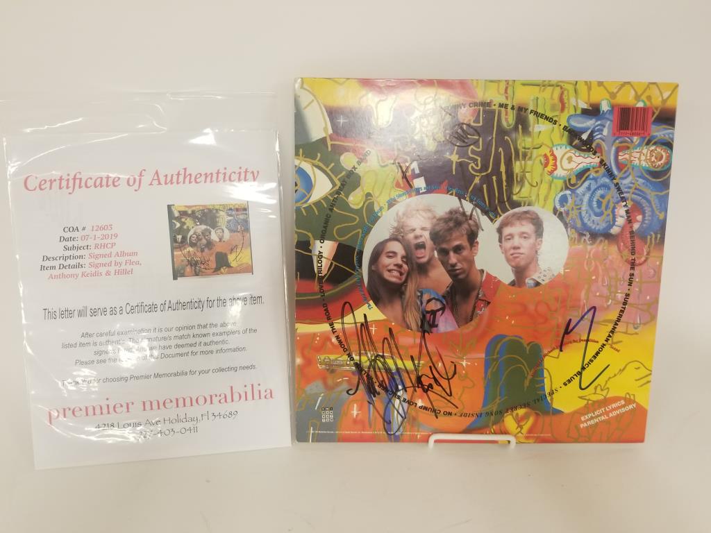 Red Hot Chili Peppers autographed album: RHCP autographed album cover with album. Signed on the back by Flea, Anthony Keidis & Hillel. Authenticated by Premier Memorabilia, comes with certificate of authenticity.