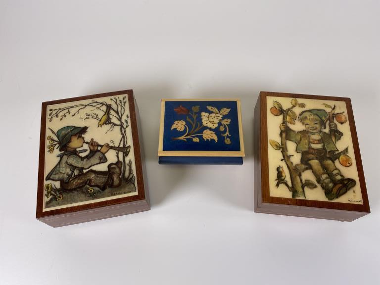 3 Music boxes: Including two Hummel and one Swiss, all working, 2 - 2.25 inches tall, 4.5 inches wide.