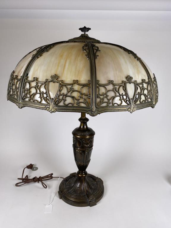 Antique slag glass table lamp: eight panel caramel slag glass shade, decorative metal base, shade is 9 inches tall, 20.5 inches diameter, table base stands 26 inches tall, missing the original bracket that the lamp shade rested on.