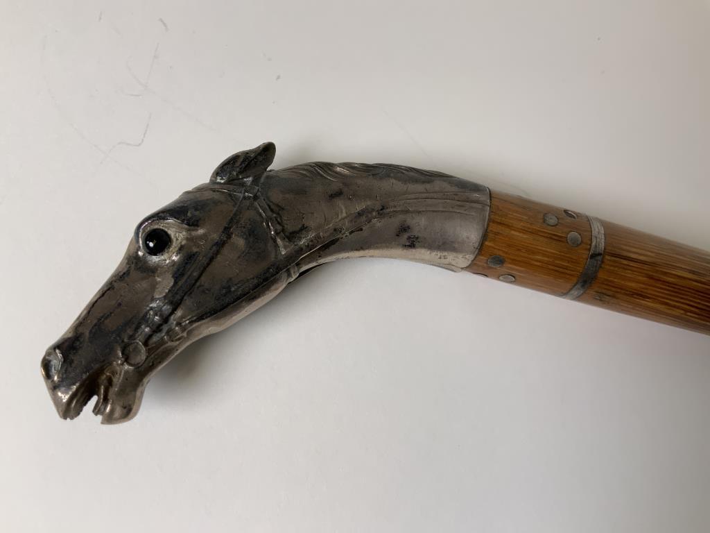 800 Silver horse head walking stick Horse head with: Horse head with single brown glass eye, one eye missing, Touch marked silver, Wooden Walking stick, length 37 inches