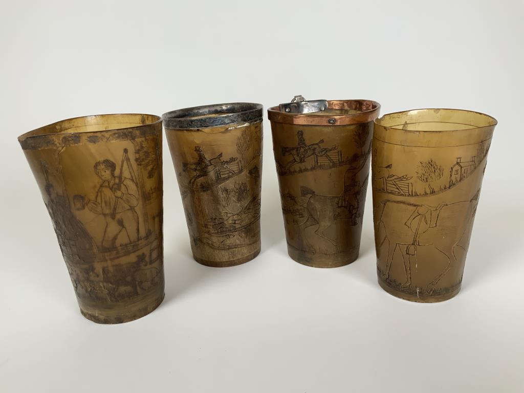 19th Century Horn Beakers To include a banded: To include a banded Tally-Ho, unmarked, has damage, band intact, copper banded hunting scene, horse and riders with dogs, no band and a country scene, no band. They are approx. 4 - 4.25 inches tall. A