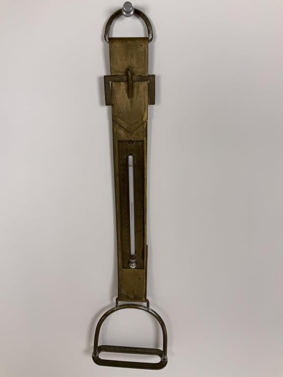 Stirrup and Strap Thermometer thermometer on metal: thermometer on metal strap with stirrup, 15.75 inches long, 4 inches wide. Bracket missing to hold top of thermometer in.