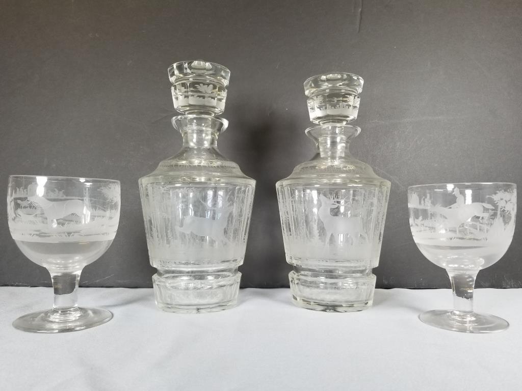 Etched glass decanters and goblets 2 etched clear glass: 2 etched clear glass decanters with stag forest scenes, each measures 10 inches tall. Two 4.75 inch tall goblets, fully etched with fox hunt equestrian scenes.