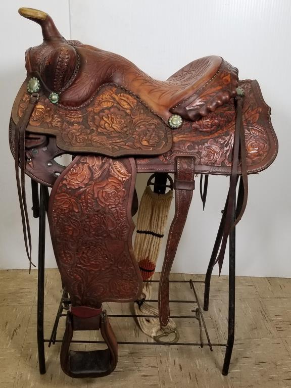 Ornate tooled Vintage leather western saddle: beautifully tooled large roses and leaf design, shaped seat, metal conchos. 16 inch seat, Western equitation saddle. Includes metal folding saddle rack.