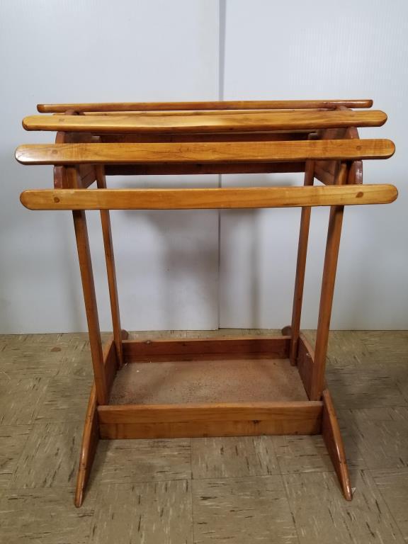 Wooden saddle stand with horseshoe on each end: horseshoe on each end to hold bridle. Measures 35 inches tall x 32 inches long x 31 inches wide at the base.