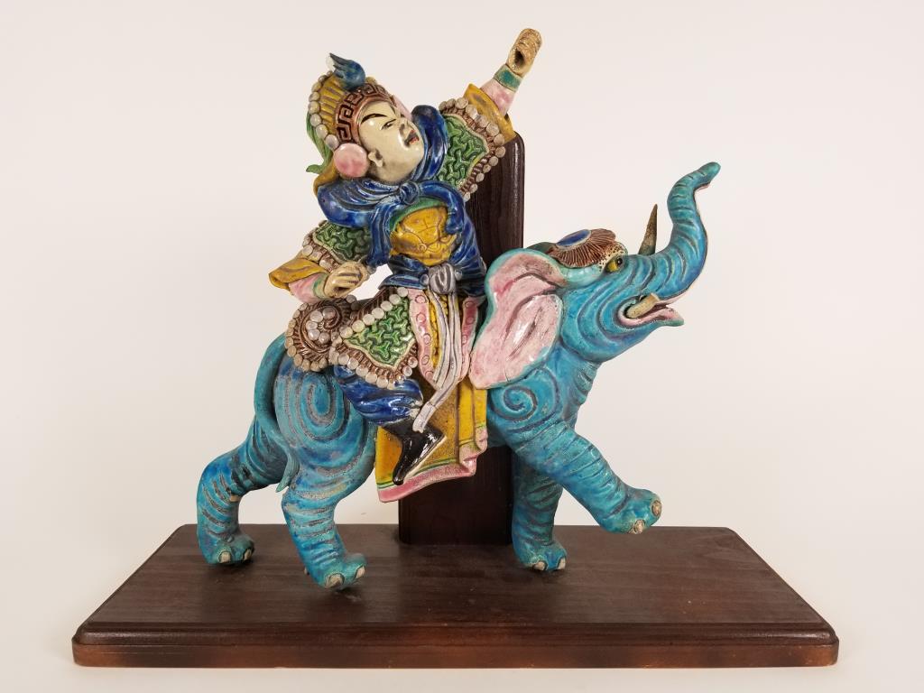 Beautiful Japanese roof tile enamel paint decorated: enamel paint decorated warrior on elephant, one tusk broken, wooden base, tile is 12 inches tall x 12 inches long, wooden base is 15 inches long x 5.5 inches wide. A chip on his helmet.