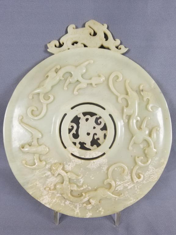 Carved Jade disc decorated with full body dragons, disc: decorated with full body dragons, disc is 10 inches diameter with an additional dragon piece mounted on top approximately 2 inches tall x 5 inches long, some discoloration on both sides.