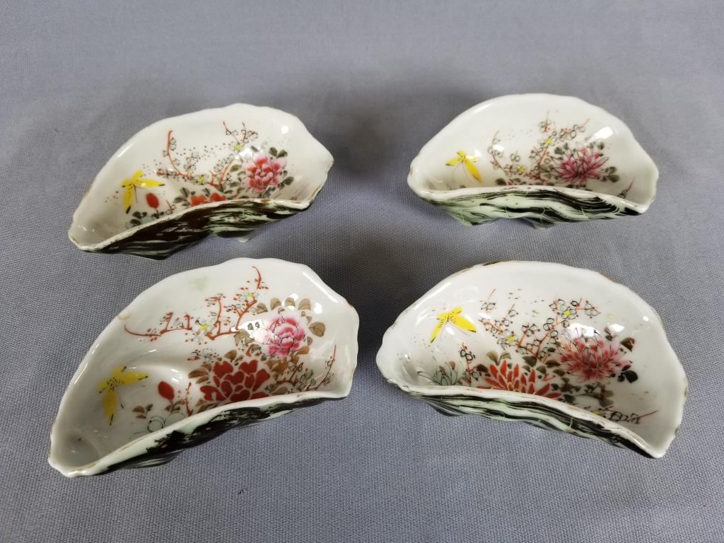 Set of four hand painted oyster dishes each dish shaped: each dish shaped like an oyster shell and hand-painted with flowers and butterflies, 5 inches long x 3 inches wide x 1.5 inches deep, unsigned.