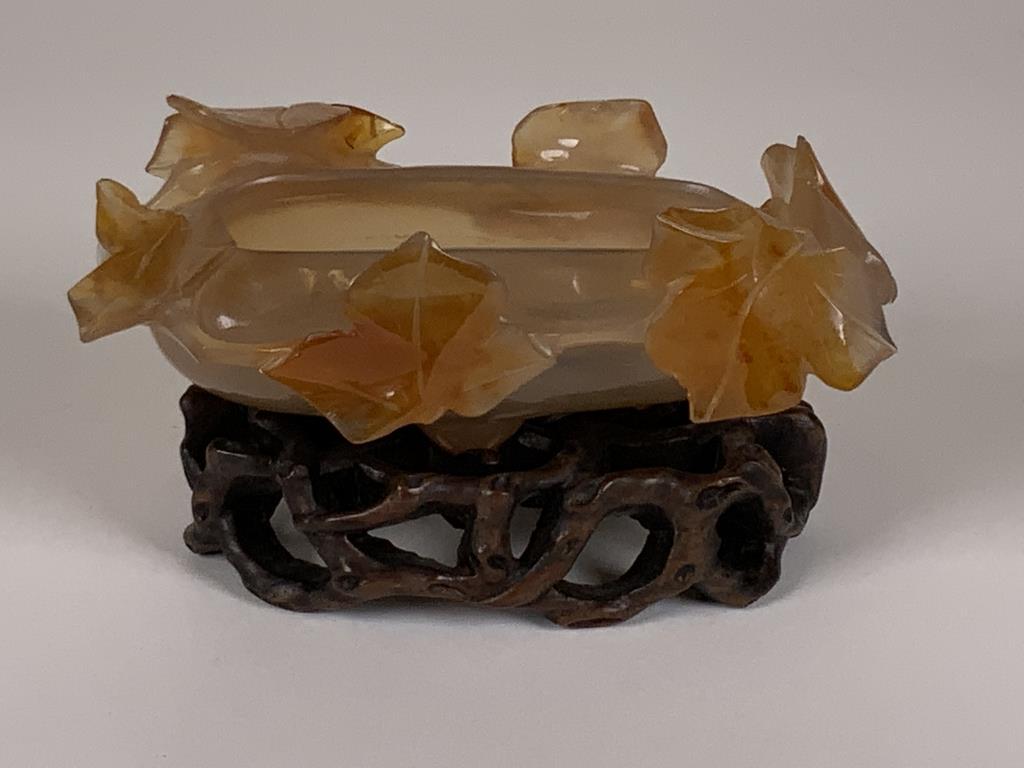 Chalcedony Agate Carved bowl with stand six leaves: six leaves carved around top of bowl, measures 1.5 inches deep x 4 inches long x 2.5 inches, bowl sets on a wooden base, .75 inches tall x 3.25 inches long x 2 inches wide