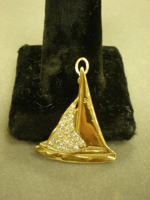 Sail ship diamond pendant. 14K yg (marked) depicti: Sail ship diamond pendant. 14K yg (marked) depicting a sail ship with pave' set diamonds, approx. 0.30ct TWD, 30mm x 25mm, 3.4dwt.