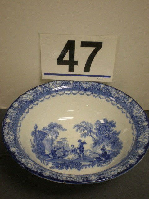 Doulton Watteau flo blue bowl. Wash bowl with Watte: Doulton Watteau flo blue bowl. Wash bowl with Watteau pattern border, center interior romantic garden scene and three exterior romantic garden scenes, 4 7/8" H, 14 3/4" diameter, cobalt Burslem, Engla