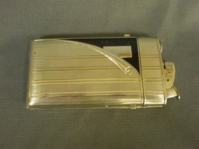 Evans cigarette case/lighter. Chrome w/blk enamel d: Evans cigarette case/lighter. Chrome w/blk enamel decoration, 5" x 2.5".