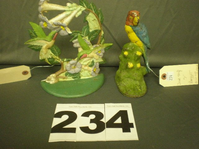 Lot of Two Cast Iron Doorstops: 7" cast iron parrot doorstop and 7 1/2" hummingbirds doorstop.