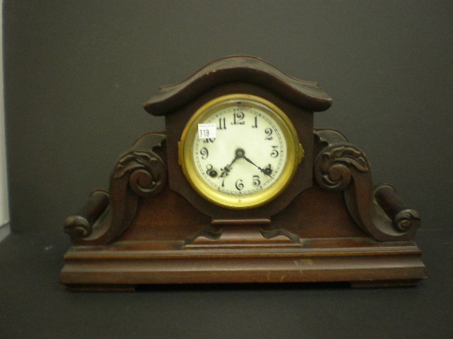 Mantle Clock: New Haven wood case mantle clock, porcelain face, key wind.