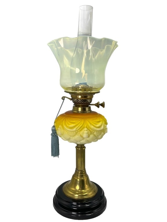 British Antique Kerosene Lamp Uranium Shade: Molded glass body with ombré coloration. Brass toned pedestal with ceramic base. Double wick burn knobs marked British made. Unique flattened bulb hurricane and what appears to be a married urani