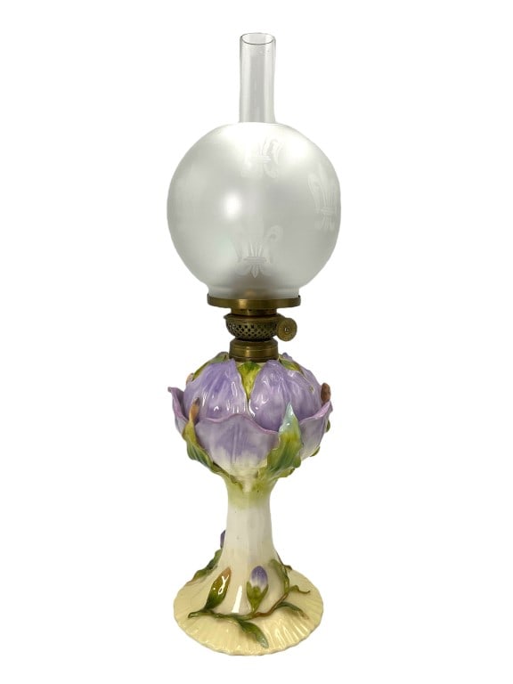 Victoria Carlsbad Austria Purple Floral Oil Lamp: Beautiful antique lamp. Porcelain body with purple florals and petal. Bulbous fleur de lis etched shade and a hurricane insert. Bottom marked with a crown Carlsbad Austria mark. Completed it stands 18