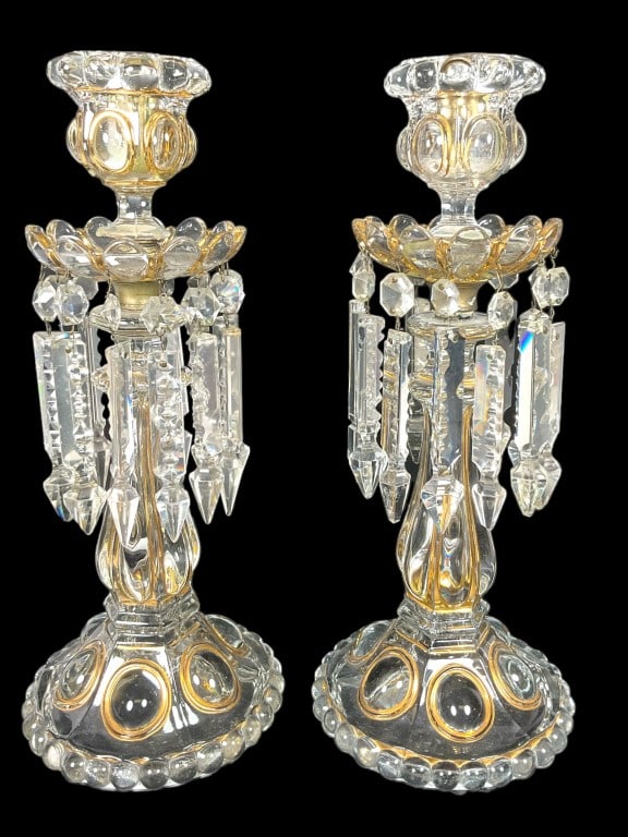Early Baccarat Style Prism Candle Holders: Glass candle holders, lusters with prism hangs. Appear pressed. Resemble Baccarats Medallion Lusters. Each are 13.5 inches tall. A prism is missing on one. Some nicks in prisms. Both candle cups have 