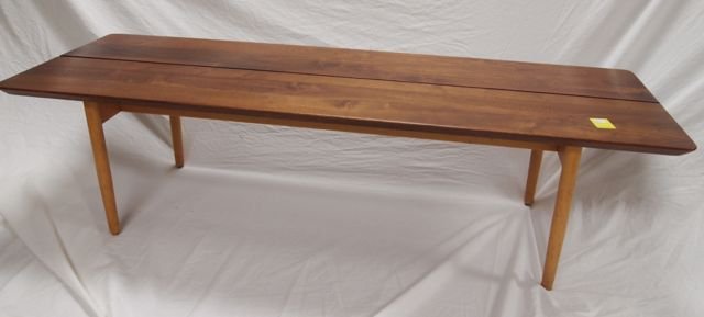 Knoll solid walnut plank table,: maple legs, oil finish; 60" long, 20.25" wide, 16" tall; thin circle mark on one panel, 2.5" in diameter; 2 small .05" dents in one board.