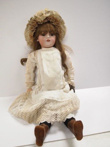 Porcelain Doll: 27" sleep eyes, fixed mouth, porcelain doll, with antique dress, hat and leather shoes, carrying a German silver change purse.
