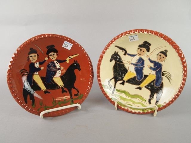 Lot of Two MOdern Redware Pottery Plates: Two modern redware pottery plates, 7.5" diameter, both plates depicting Revolutionary figures on horses, impressed Selinda Kennedy Clayworks.