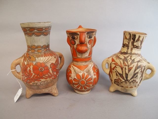 Three Mexican Items: Two 3-footed vases, one is 9", other is 8" in clay, ornately decorated with birds and flowers; 8" pitcher decorated with birds with figural faced spout.