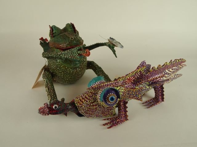 Two Outside Folk Art Figures Gonzalez: Two paper mache' brightly colored figures, 8.5" x 11" x 9" green seated frog with butterfly and a 5.5" x 20" x 4" brightly colored fish with two fish hanging out of its mouth, signed Gonzalez.