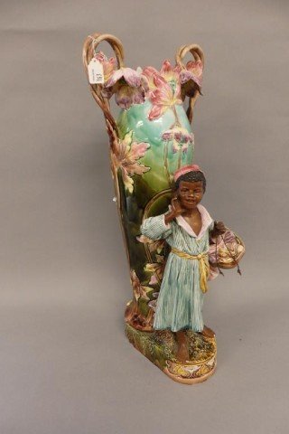 Majolica Vase: 25" tall brightly colored Majolica vase w/2 handles & full body Blackamoor figure of a young boy holding basket of seashells, repair to both handles, some minor flaking to base
