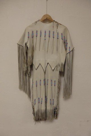 American Indian Style Leather Garment: Off white Leather Dress with red, white and blue beads, tasseled sleeves and boarder