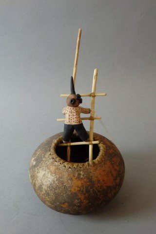 American Indian Pot: Pot measures 3" x 5" in a gourd pot with a 3.5" figure of man climbing ladder out of the pot. Artist signed- Robert Rivera,Santa Fe New Mexico, 2-19-88