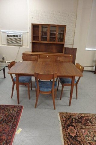 Drexel Danish Style Dining Room Set: Eight piece walnut Drexel Danish style dining room set includes table with three extensions, four side and two armchairs and hutch with original white porcelain knobs.