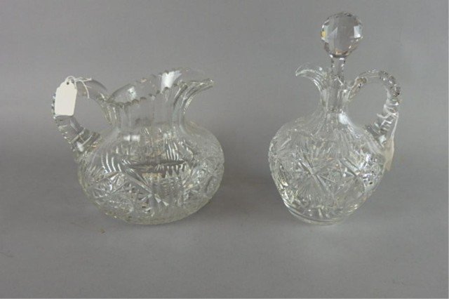 2 Cut Glass Items: 1) Water pitcher measures 6.5" H 2) Carafe which is 9"h. Highly cut decoration. Very nice condition