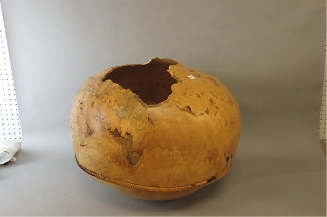 David Ellsworth Bowl: Norway maple burl 17" tall x 21" dia. bowl w/leather strap adjoining top & bottom, some breakage, 1987