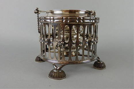 Georg Jensen Sterling Beverage Warmer: Four-footed Georg Jensen sterling beverage warmer, 5.25" T x 5.5" W, warmer set inside cage-like encasement, reticulated and beaded, atop four covered feet, warmer has lid revealing wick, marked