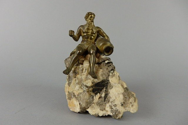 Bonze Figure on Quartz Base: 4.5" T x 3" W x 4" D bronze figure of Neptune atop grey quartz base holding a pitcher jug; missing fishing implement, e.g., fishing spear.