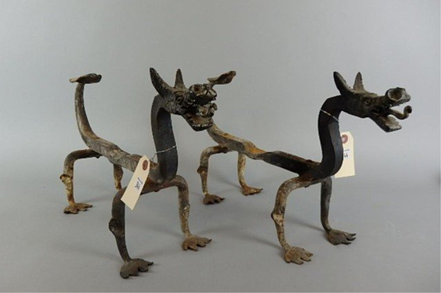 Pair of Figural Andirons: 11" T x 19" W pair of wrought iron fireplace andirons, dragon form with extended tongues.