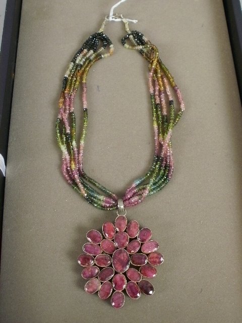 Ruby & Emerald Necklace: 18" ruby & emerald five strand necklace, with 2.5" x 2.5" pendant, consisting of 25 rubies set on the silver pendant.