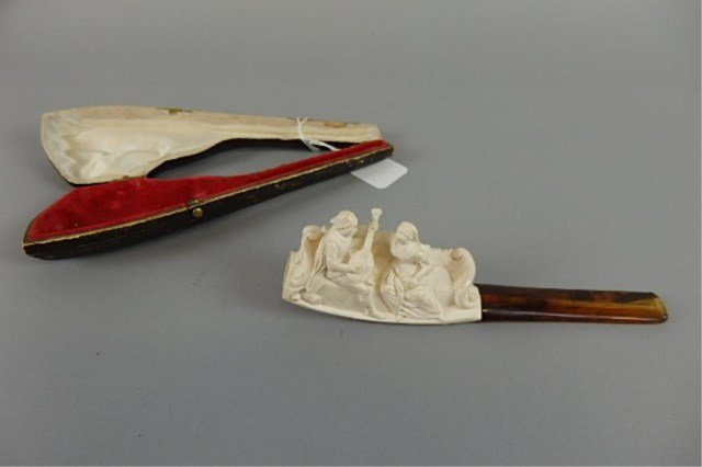 Meerschaum Figural Pipe: Meerschaum figural pipe of a man seranading a woman seated on a fancy settee' with case.