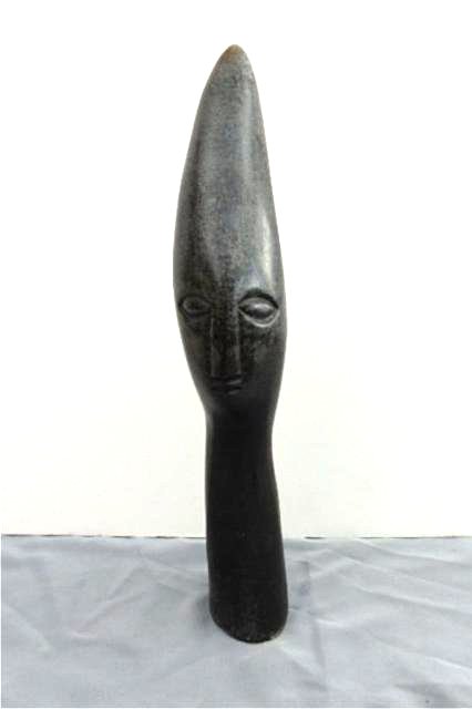Stone Carving: Elongated face, measures 17" x 5" x 3", Weight approx. 5-10 lbs Artist: Bvumbi Title: Cone Head Medium: Spring stone