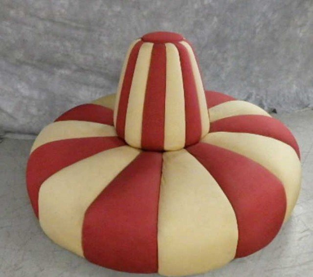 Round Seating Piece-possibly hotel entrance way: Round seating piece with cushioned back in center, red and gold alternating colored cushioned seats, 62" diameter, seats 15.5" high, back 22" high. This item has a strong cigar smoke odor.