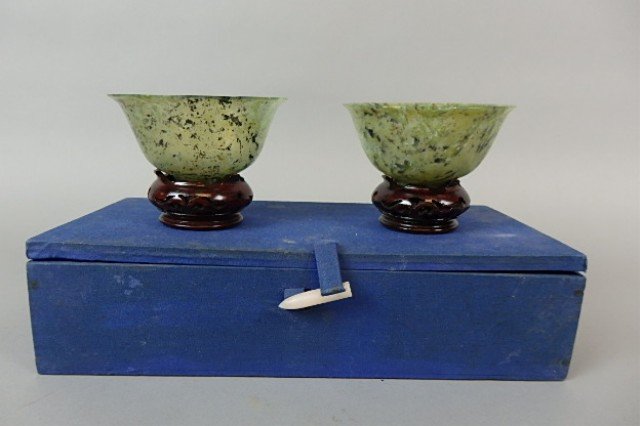 Pair of Spinach Jade Cups: 2" x 4" diameter pair of spinach jade handleless cups with teakwood stands in a fitted box.