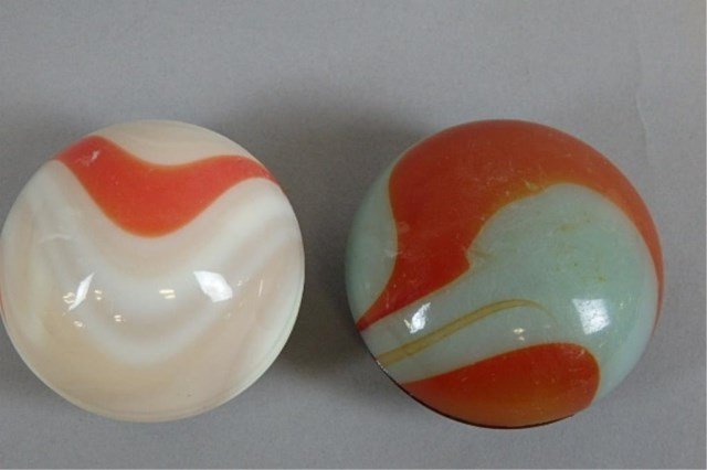 Lot of Two Antique Gear Shift Knobs: 1.5" x 2.25" orange and 1.75" x 2.25" white antique gear shift knobs.