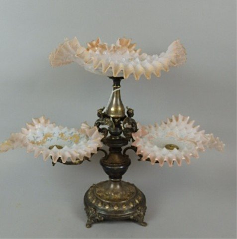 Victorian Epergne: 17" tall x 21" long x 12" wide elaborate silverplated Victorian eperngne, figural base, with two winged creatures, holding two 9.5" satin handpainted candy ribbon bowls, the top bowl is shell shaped 1