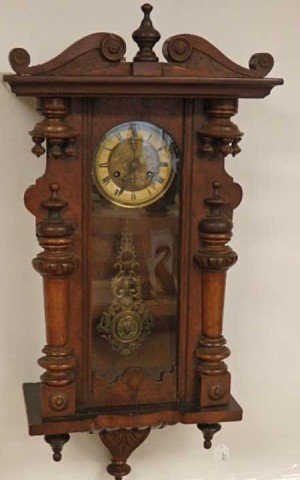 Early Wall Clock: Circa 1890's 36" x 14.5" x 7" walnut wall clock, ornate reposee' brass face, with a full body stag, ornate brass pendulum with lion's face and woman's profile, key wind.
